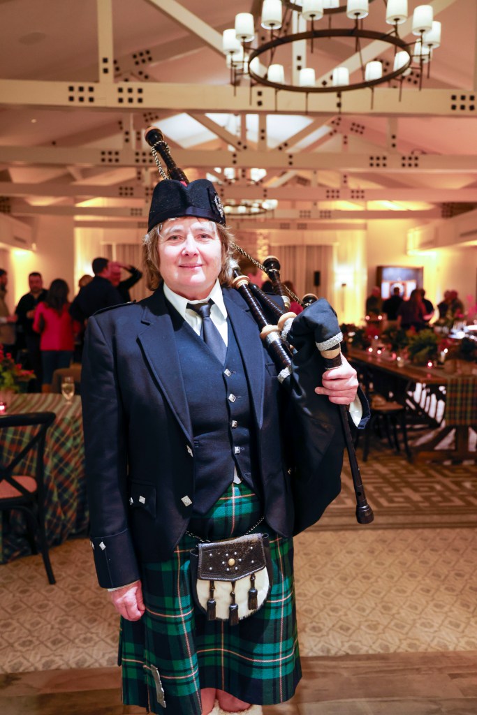 Scottish Great Highland Bagpiper Elise MacGregor Ferrell poses between playing Celtic bagpipe tunes in Pebble Beach, California.